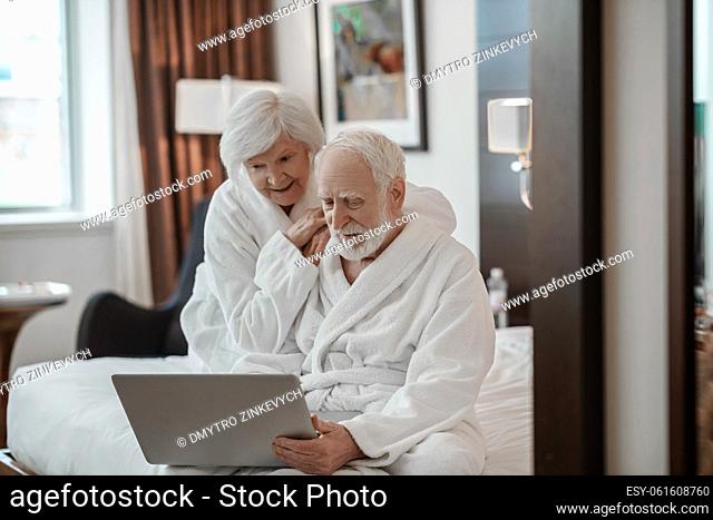 Togetherness. Elderly couple in a hotel room having good time