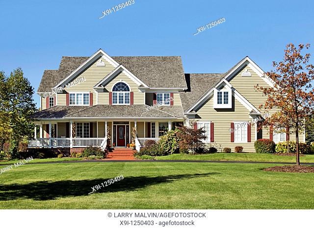 Large suburban home with front porch and cedar roof