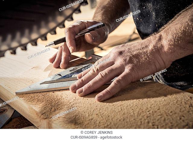 Close up of male carpenter with set square in workshop