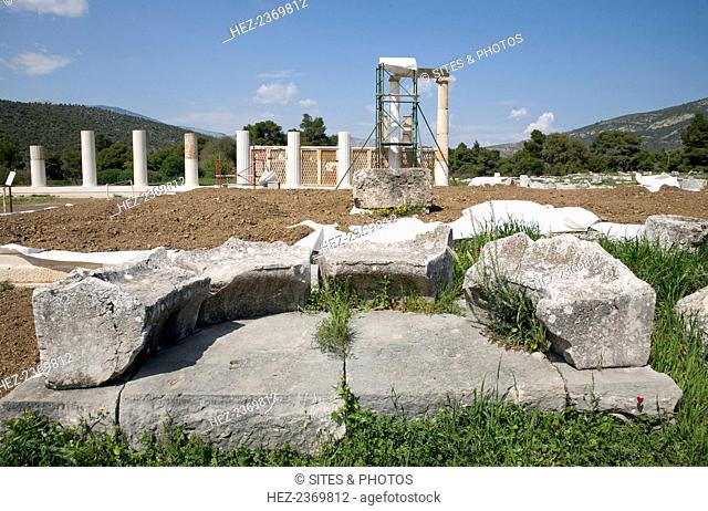 An exedra in Epidauros, Greece. The original Greek sense of exedra (a seat out of doors) was applied to a room that opened onto a stoa