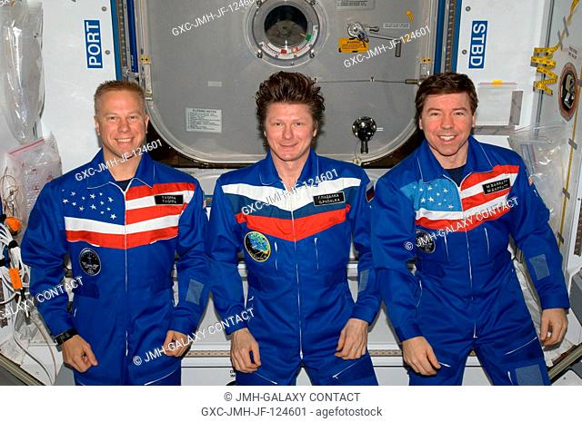 Cosmonaut Gennady Padalka (center), Expedition 20 commander; along with NASA astronauts Tim Kopra (left) and Michael Barratt, both flight engineers