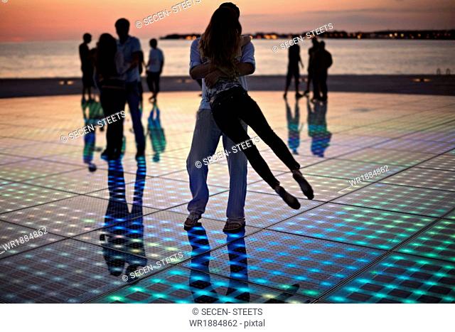 Croatia, Dalmatia, Solar panels as a dance floor, sunset in background