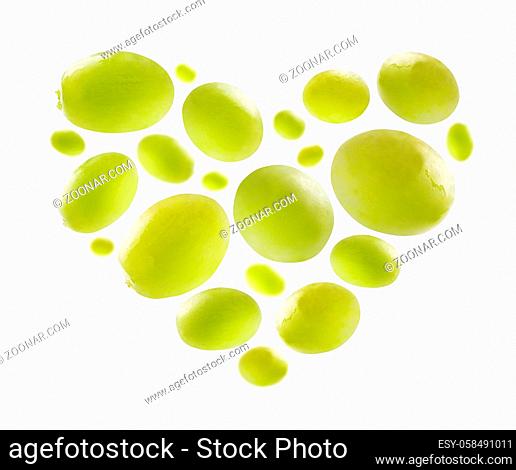 Green grapes in the shape of a heart on a white background