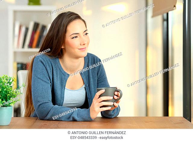 Relaxed woman contemplating at home