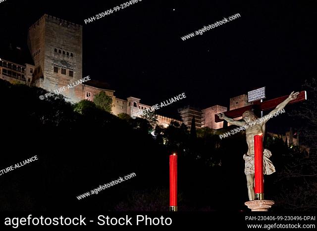 05 April 2023, Spain, Granada: The Cristo del Consuelo (Christ of Consolation) passes in front of the Alhambra. The procession lasts about 12 hours and follows...