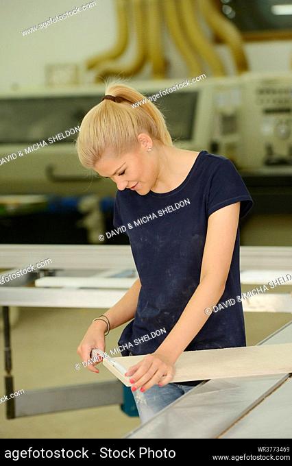 Young woman working in a carpentry