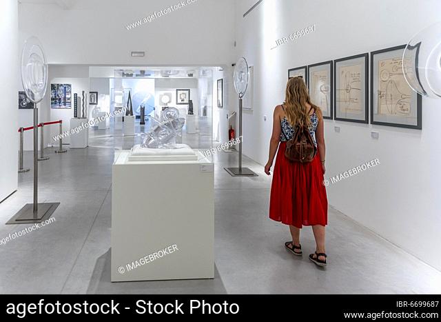 Young woman in the glass museum looking at hand-blown glass, Museo del Vetro, Murano, Venice, Veneto, Italy, Europe