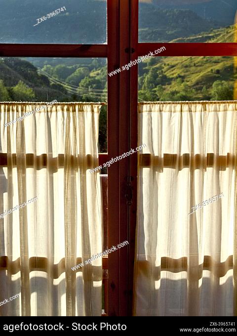 Balcony window from inside apartment at Boí-Taül Resort, Pla de la Ermita. Boí Valley, Alta Ribagorza region. Lleida province, Catalonia, Spain