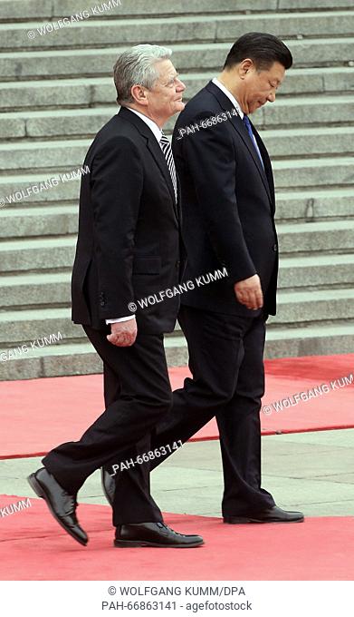 German President Joachim Gauck (L) is received by his Chinese counterpart Xi Jinping during a welcome ceremony at the Great Hall of the People in Beijing, China
