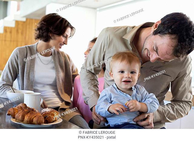 Family having breakfast at a kitchen counter