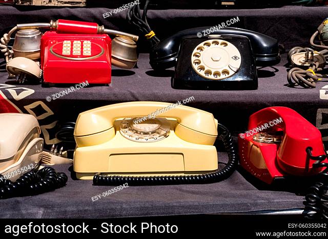 Old vintage telephones on a memorabilia shop display. Beautiful wallpaper background image. No people