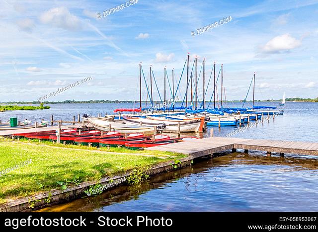 Water landscape with small sailboats in the harbor of a lake called Leekstermeer in Drenthe in the Netherlands