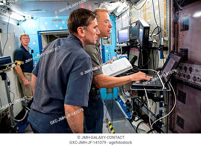 NASA astronaut Tim Kopra, Expedition 46 flight engineer and Expedition 47 commander; Russian cosmonaut Yuri Malenchenko (foreground) and European Space Agency...