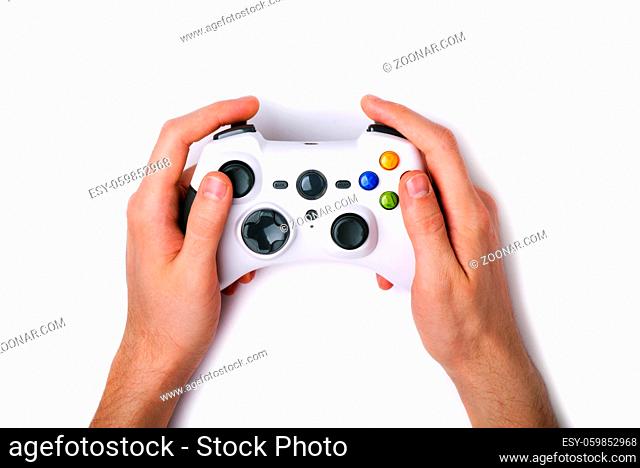 Video game console controller in gamer hands isolated on white background