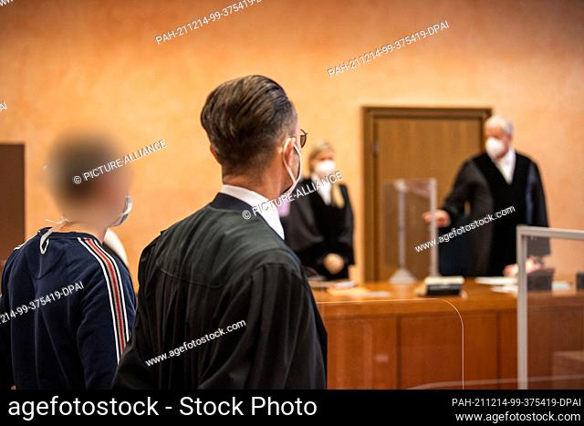 14 December 2021, North Rhine-Westphalia, Detmold: The defendant (l) stands next to his lawyer in the trial for negligent bodily injury caused by faulty dental...