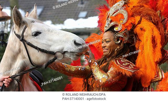 Isis, A Brazilian Mangalarga Marchador horse breed, stands next to a Brazilian Samba dancer Eliana during preleminary photo session of the equestrian sports...