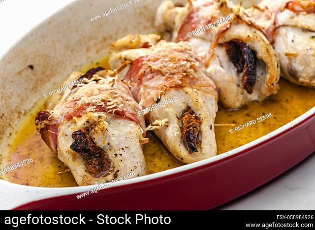 chicken rolls stuffed with dry tomatoes in bacon