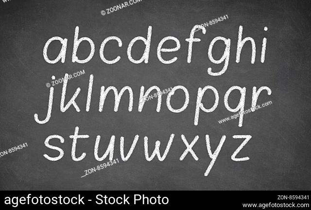 Handwritten letters of the alphabet written on a blackboard