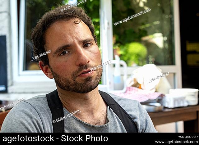 Berlin, Germany. Portrait of man, making confessions during a conversation