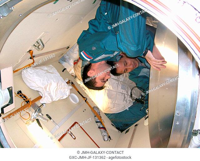 Cosmonaut Yuri I. Malenchenko (foreground), Expedition 7 mission commander, and astronaut Edward T. Lu, NASA ISS science officer and flight engineer