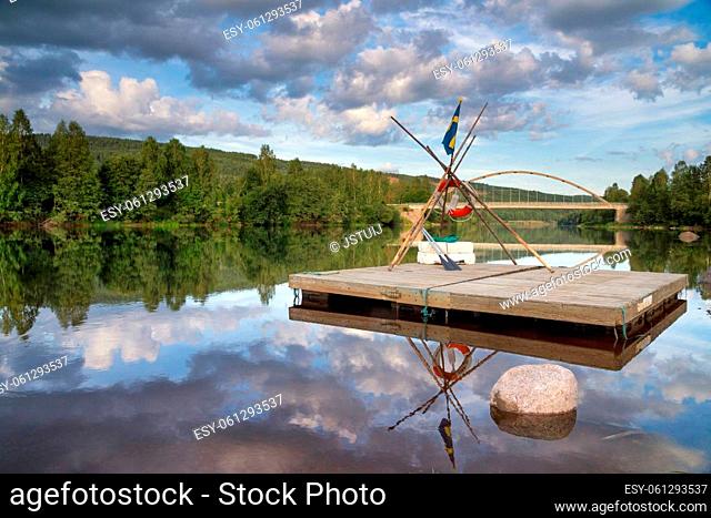 Floating raft in front of a bridge over the Klaralven river near Branas in the province Varmland