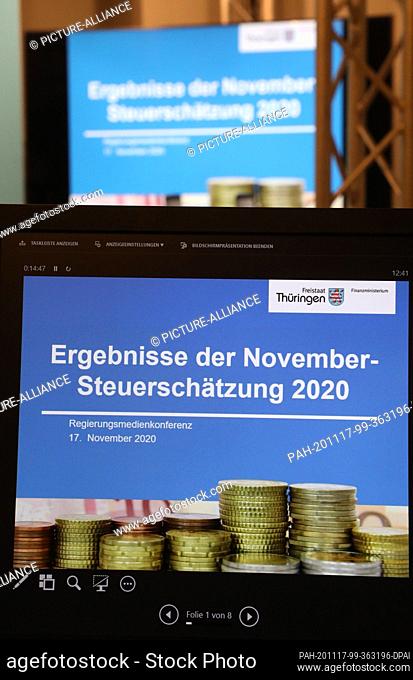 17 November 2020, Thuringia, Erfurt: ""Results of the November tax estimate 2020"" is on a monitor at the government media conference of Thuringia's Minister of...