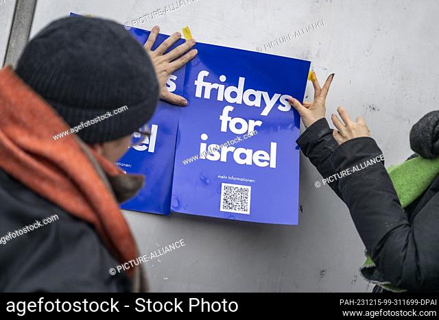 15 December 2023, Berlin: Participants in a Fridays for Israel demonstration stand in front of the entrance to the cafeteria of Freie Universität Berlin and...