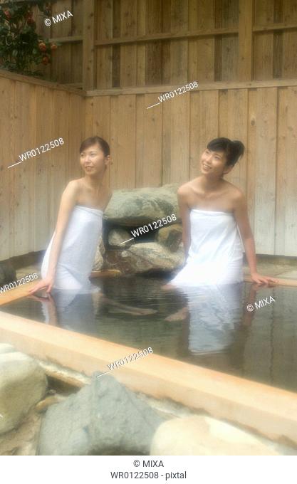 Two young women bathing in hot springs