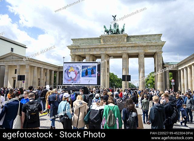 27 May 2022, Berlin: Participants stand in front of the Brandenburg Gate during a rally for the protection of Antarctica. Photo: Christophe Gateau/dpa
