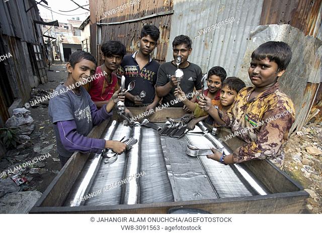 Spoon-Making Factory Workers at a steel recycling and steel spoon making factory in Dhaka. Many child labors are working a spoon factory at Hajaribag near of...
