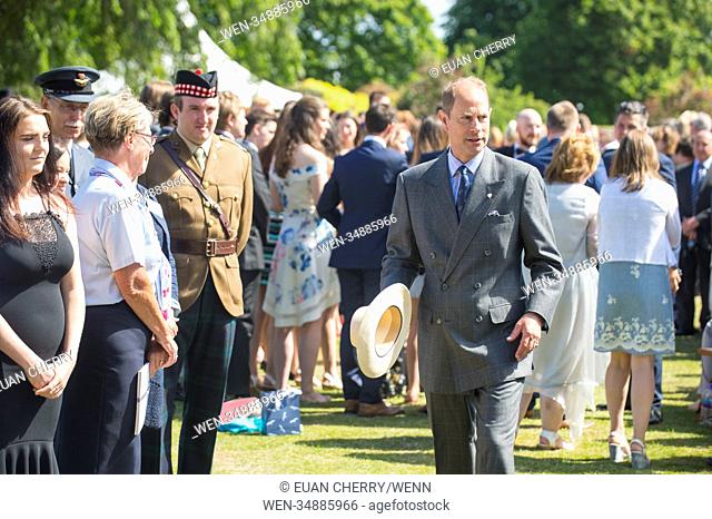 Prince Edward, Earl of Wessex shields himself from the heat under a hat as he attends the Duke of Edinburgh Gold Awards at the palace of Holyrood house