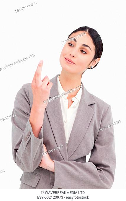 Businesswoman looking at her fingertips against a white background