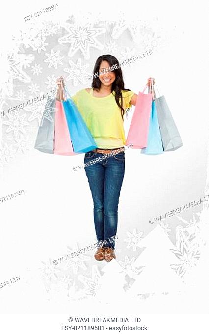 Composite image of beaming woman student with shopping bags