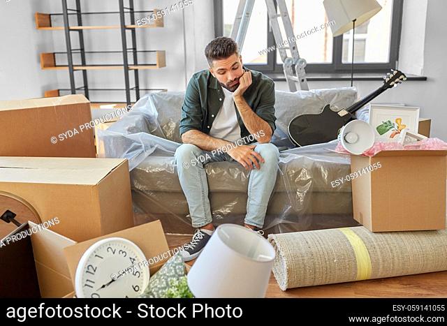 sad man with boxes moving to new home