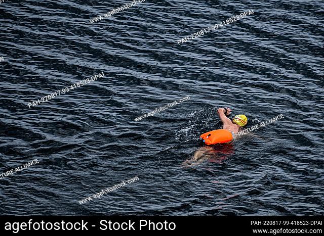 17 August 2022, Lower Saxony, Schulenberg: A swimmer crawls in the Okertalsperre in the Harz Mountains. Photo: Swen Pförtner/dpa