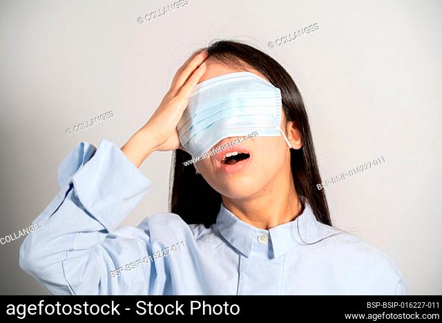Young woman wearing a mask over her eyes