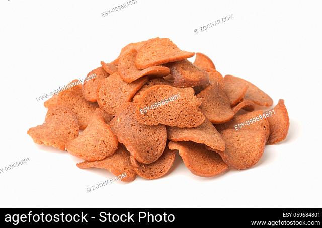 Pile of rye bread chips isolated on white