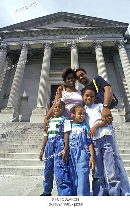 Family of tourists on the steps of the Benjamin Franklin Institute