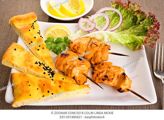 Tandoori chicken with naan bread and salad