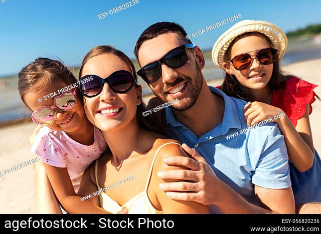 happy family in sunglasses on summer beach