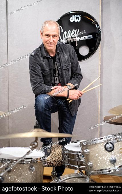 16 April 2020, Bavaria, Munich: Thomas Dessau, musician of the band ""Cagey Strings"", sits at the drums in the rehearsal studio of his band