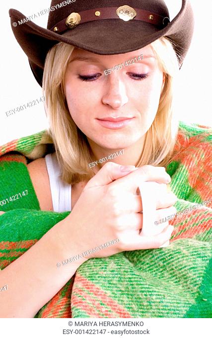 girl in a cowboy hat with cup of tea