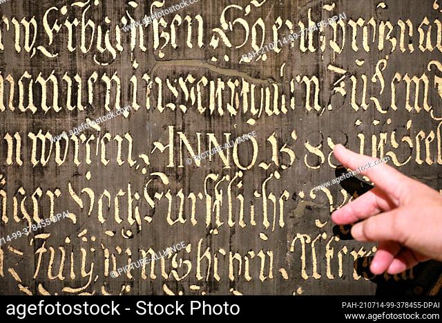 14 July 2021, Mecklenburg-Western Pomerania, Güstrow: Susanne Buch, restorer, presents the restored epitaph for Johann Cothmann (born 1588 in Lemgo
