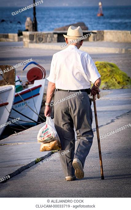 Man Walking in the Port of Aegina, Greece, Western Europe