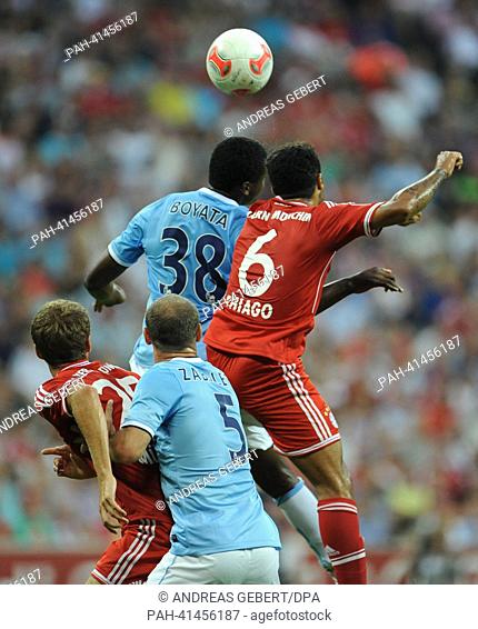 Munich's Thiago Alcantara (top R) and Thomas Mueller (L) and Dedryck Boyata (top L) and Pablo Zabaleta (R) of Manchester vie for the ball during the Audi Cup...