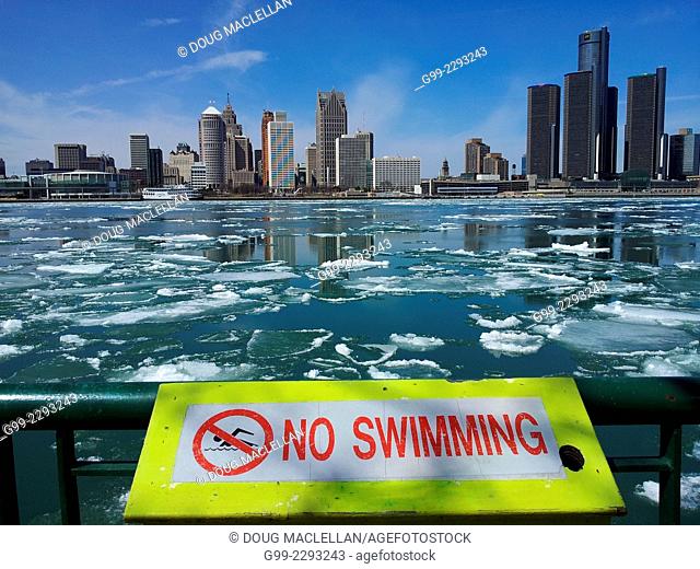Spring ice breaking, Detroit skyline (no swimming sign, ship passing.), Windsor, Ontario, Canada