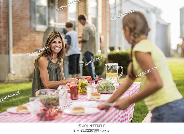 Caucasian family eating in backyard