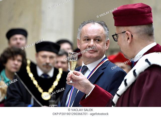 Andrej Kiska, centre, president of the Slovak Republic, receives a Great gold medal of Masaryk University from (MUNI) Rector Mikulas Bek, right