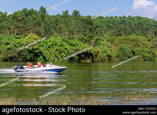 Motorboat drives over lake, jungle
