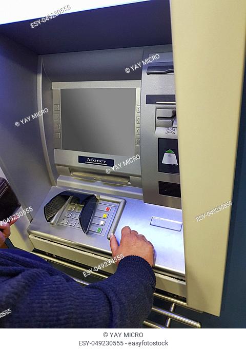 Woman at an ATM cash machine with leeen screen